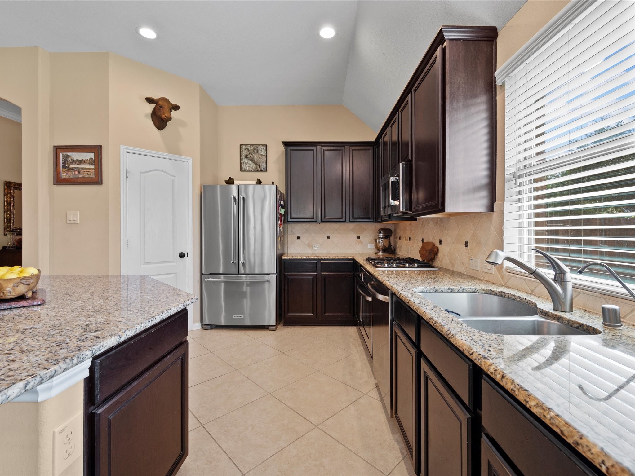 17254 Rookery Court Conroe, TX 77385 - Photo 11 of 36 a kitchen with granite countertop a sink stove and refrigerator