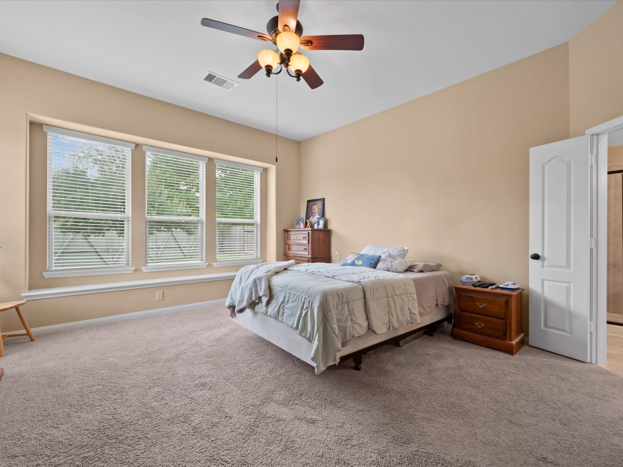 17254 Rookery Court Conroe, TX 77385 - Photo 15 of 36 a spacious bedroom with a bed and a window