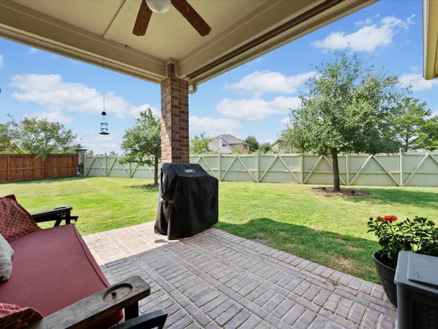 a backyard of a house with a garden and outdoor seating