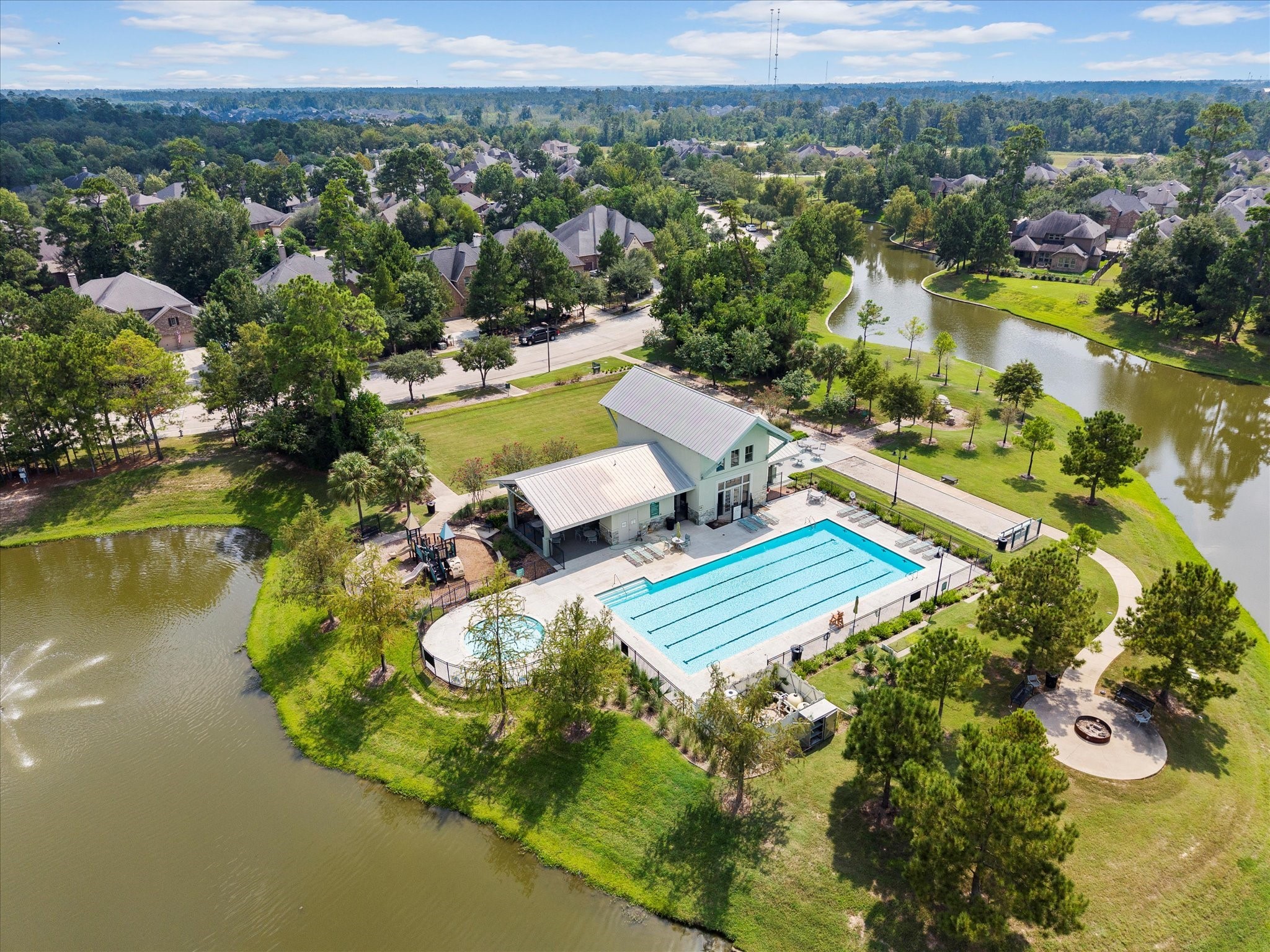 17254 Rookery Court Conroe, TX 77385 - Photo 32 of 36 an aerial view of a house with a garden and lake view