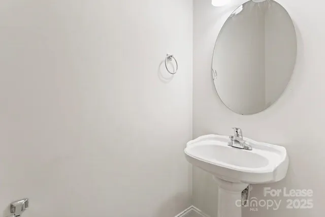 a bathroom with a sink and mirror