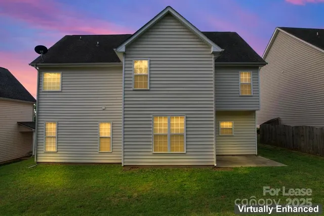 a view of a house with a backyard