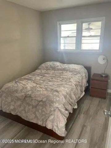 a bed sitting in a bedroom next to a window