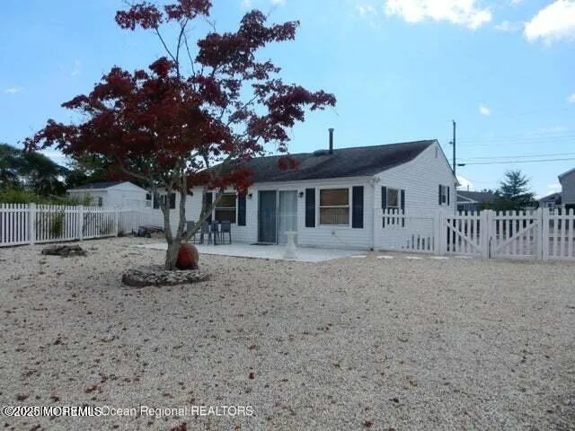 a view of a house with a tree in a yard