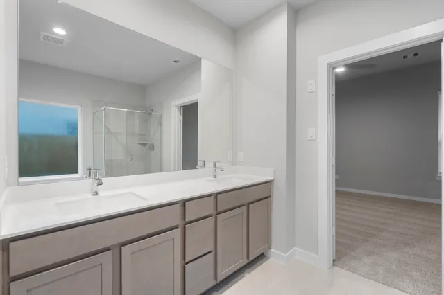 a bathroom with double sink and a mirror