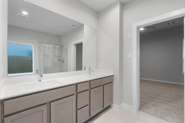 a bathroom with double sink and a mirror