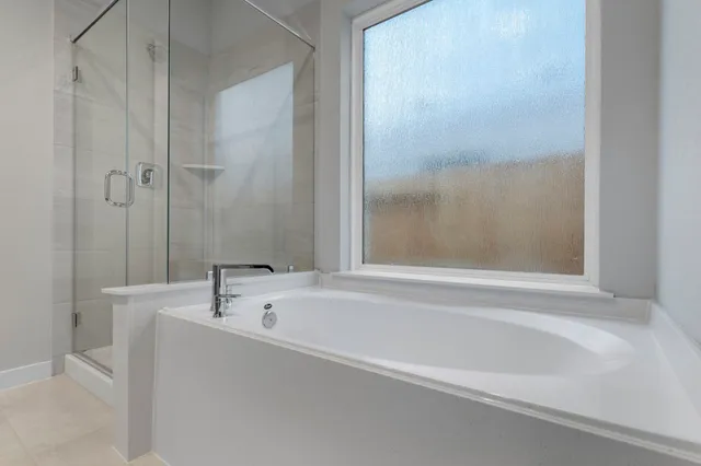 a white bath tub sitting next to a white sink