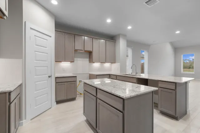 a kitchen that has a sink and a stove in it