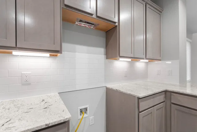 a view of a kitchen with cabinets and wooden floor