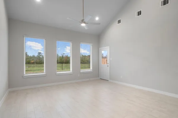 an empty room with windows and entrance