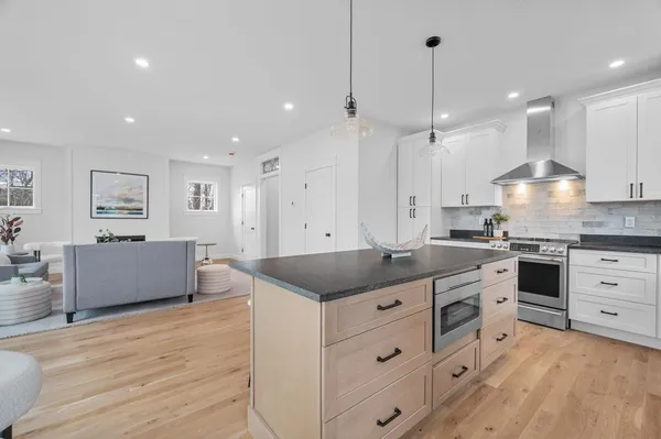 a kitchen with a stove kitchen island and stainless steel appliances