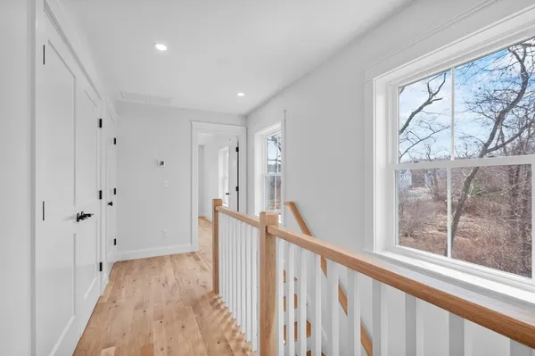 a view of a hallway with wooden floor and fence