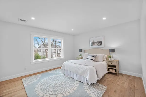 a bedroom with a large bed and a window