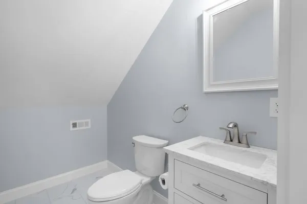 a bathroom with a sink a toilet and mirror