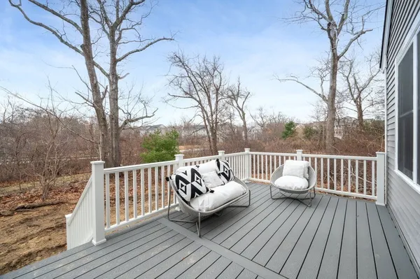 a view of a wooden deck with trees