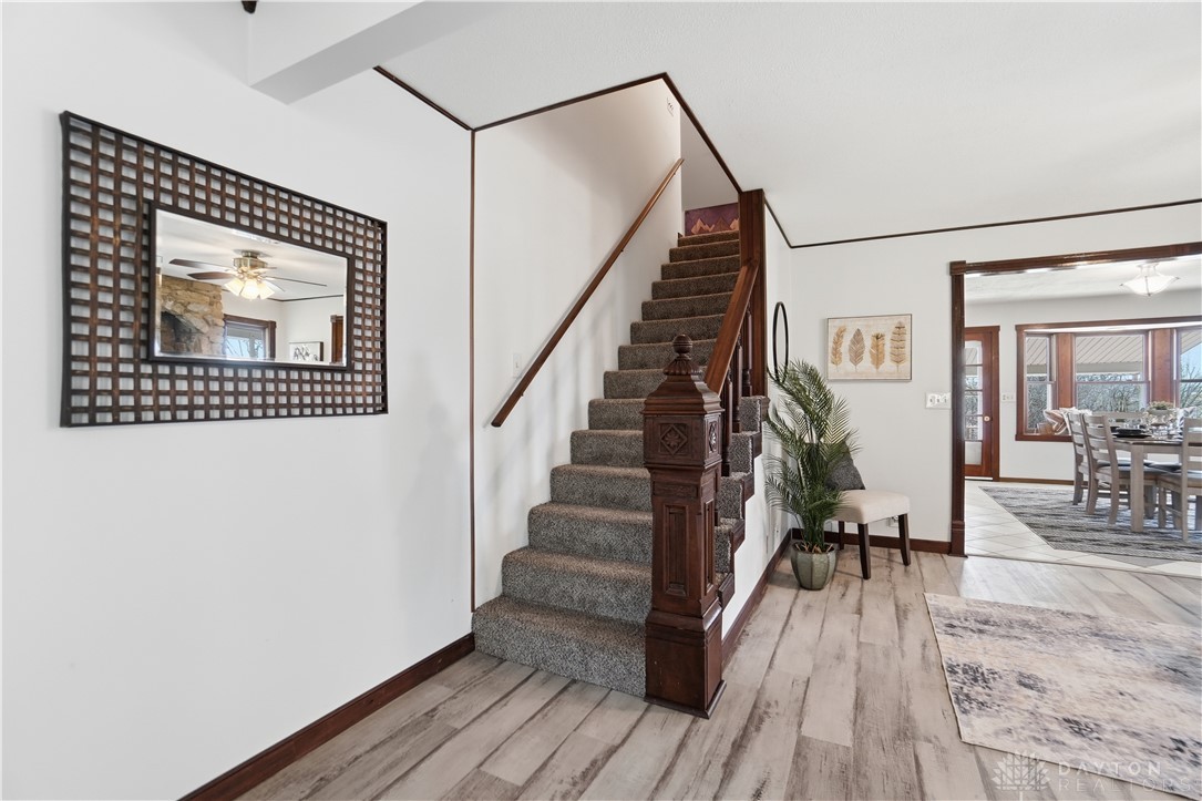 7553 Coffin Station Road Springfield, OH 45502 - Photo 33 of 95 This welcoming entryway showcases a grand staircase and elegant flooring.