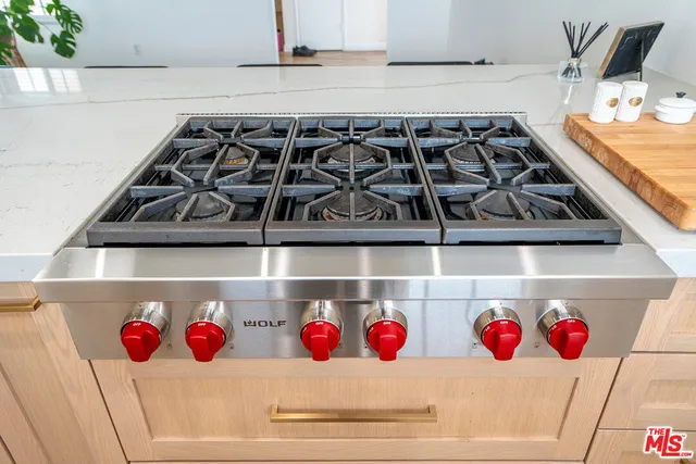 a stove top oven sitting inside of a kitchen