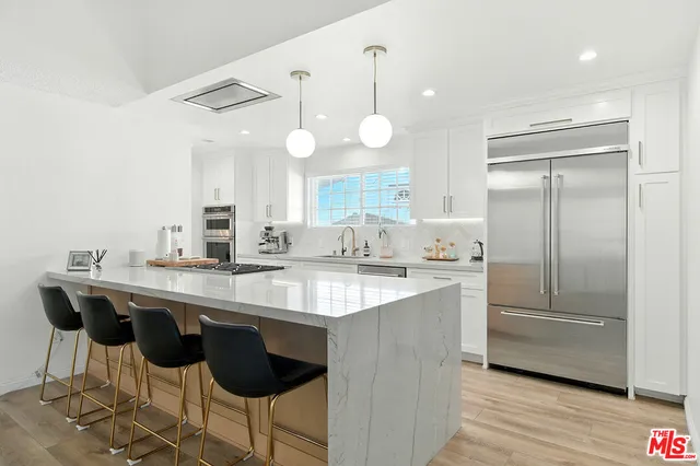 a kitchen with counter top space cabinets and stainless steel appliances