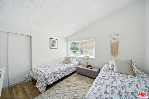 a bedroom with a bed and a table in it