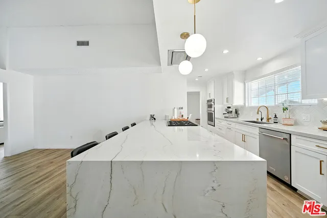 a kitchen with a stove and cabinets
