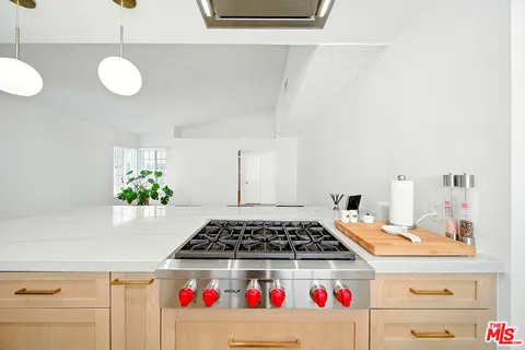 a kitchen with a refrigerator and cabinets
