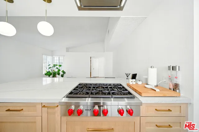 a kitchen with a refrigerator and cabinets