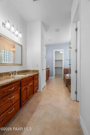 a large bathroom with a sink and a large mirror