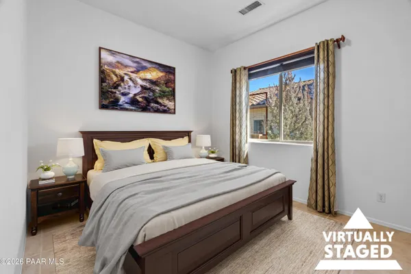 a bedroom with bed and a window