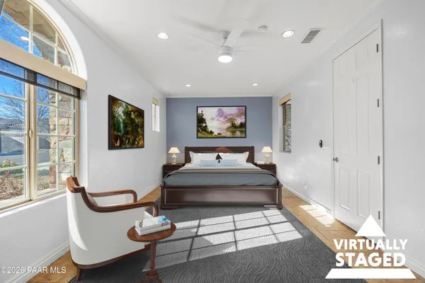 a living room with furniture a flat screen tv and a large window