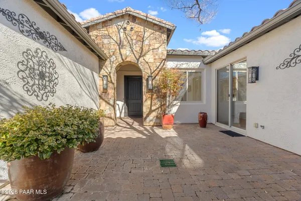 a view of a house with potted plants