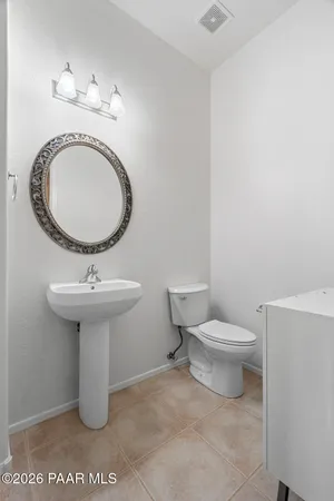 a bathroom with a sink a toilet and mirror