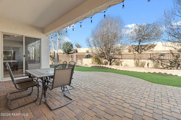 a view of a patio with table and chairs and potted plants