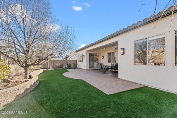 a view of a house with a yard and sitting area