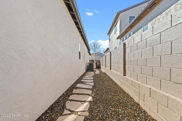 a view of a pathway with white walls