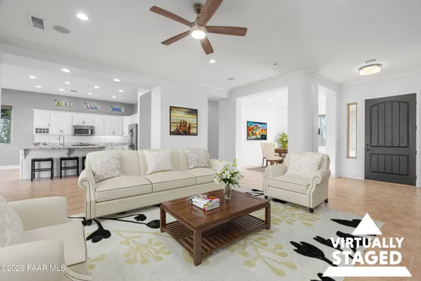 a living room with furniture and a view of kitchen