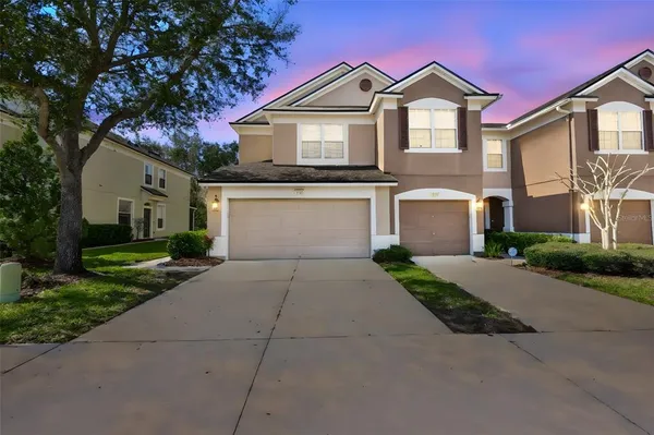 a front view of a house with a yard and garage