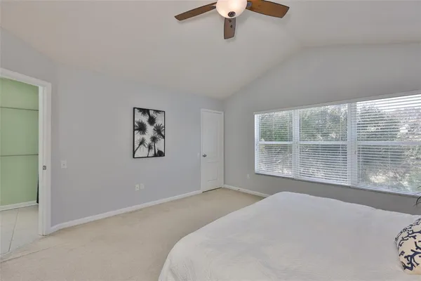 a bedroom with a large bed and a large window