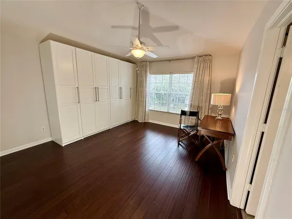 a view of a room with wooden floor and windows
