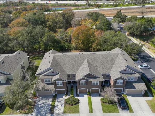 an aerial view of a house with garden space and street view