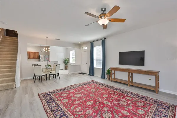 a view of a living room and entryway with wooden floor