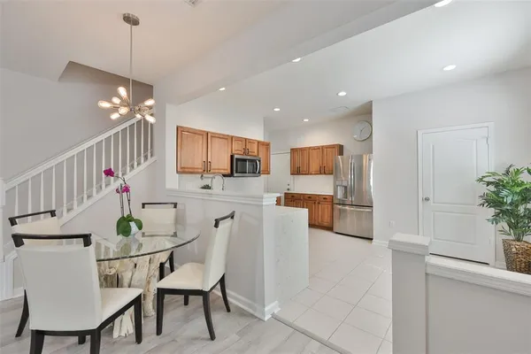 a dining room with furniture and kitchen view