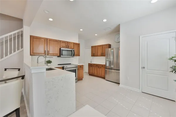 a kitchen with stainless steel appliances a refrigerator and a stove top oven