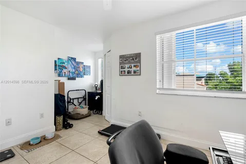a view of a workspace with furniture and a window