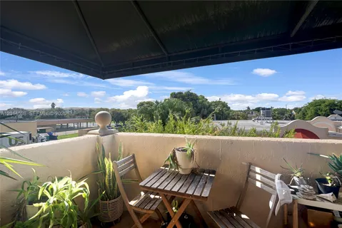 a view of balcony with furniture and a potted plant