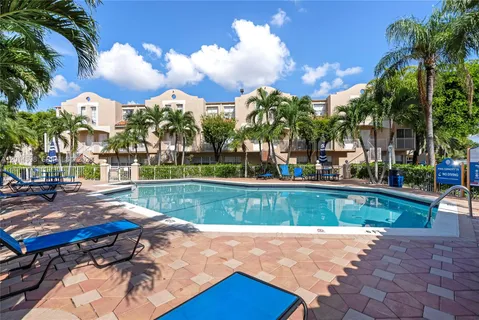 a view of backyard with swimming pool and outdoor seating