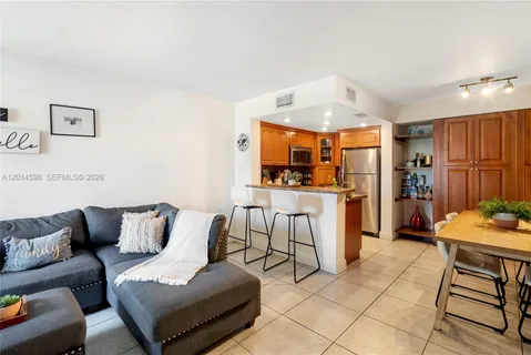 a living room with furniture and kitchen view
