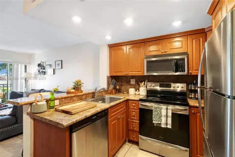 a kitchen with a sink stove and microwave