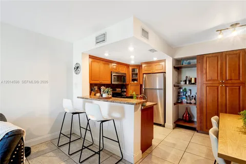 a kitchen with stainless steel appliances granite countertop a refrigerator and a stove