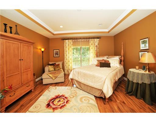 616 Northeast Francesca Lane Boca Raton, FL 33487 - Photo 9 of 14 a bedroom with a bed a table and chair