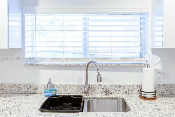 a kitchen with a sink and a window